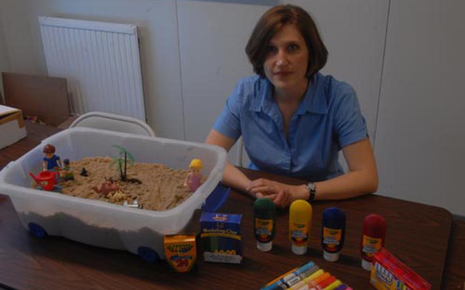 Art therapist Amanda Salisbury helps soldiers and civilians deal with trauma at Grafenwoehr using art created with paint, crayons, clay and plastic toys. The arrangement in the sandbox depicts what a Stripes reporter considers his ideal world.
