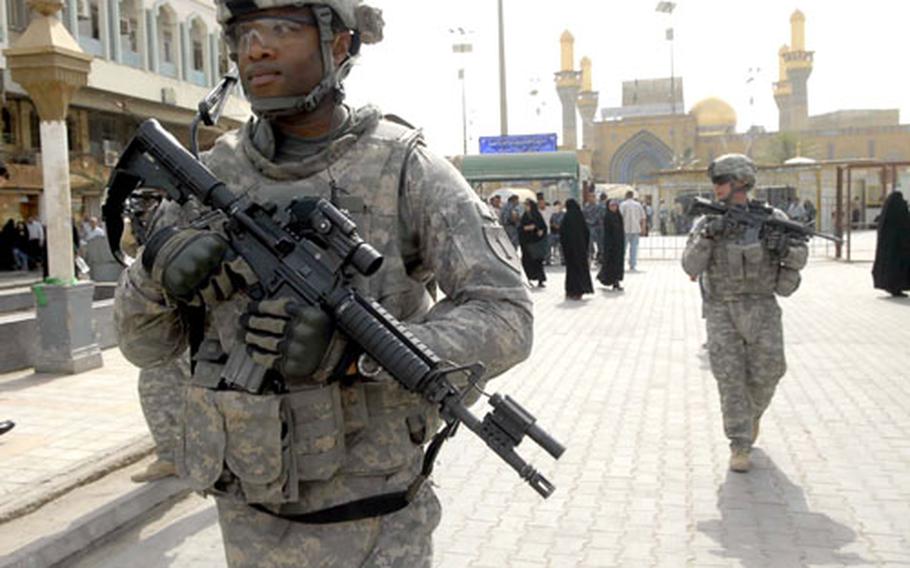 U.S. Army Sgt. 1st Class Leonard Peterson leads a patrol in Baghdad’s Khadamiyah district with the Khadamiyah shrine in the background.