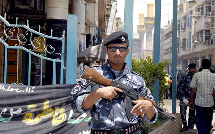 A member of the “Shrine Battalion,” a group of former militiamen that now protect the inner sanctum of the Khadamiyah shrine, stands guard at a security checkpoint near the shrine. The guards answer to a shadowy figure wanted on terrorism charges by the Iraqi government, and trust between conventional security forces and the shrine guards is low.