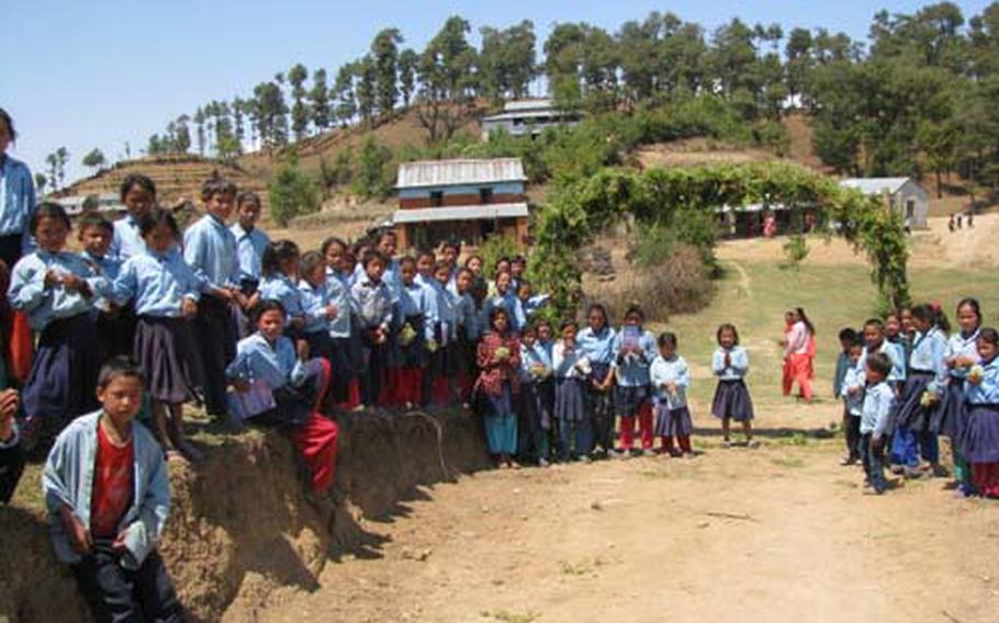Nepalese school children gather outside.
