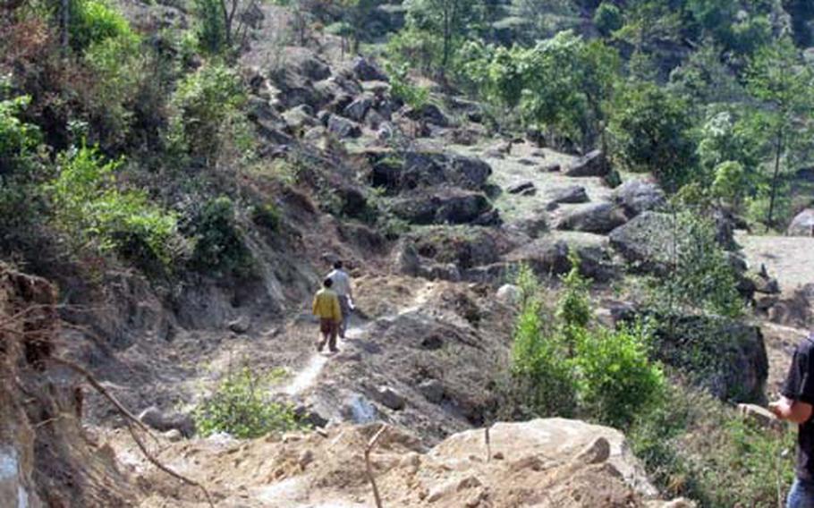Nepalese school children climb the steep trail they use to get to school earlier this year.