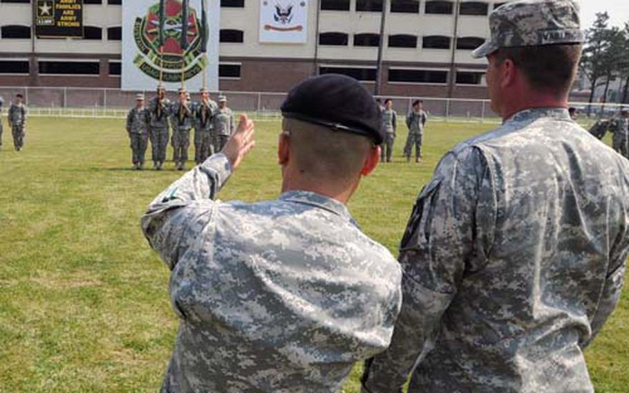 Command Sgt. Maj. Jason K. Kim, center, talks with Sgt. 1st Class Evan Vaillencourt, right, and Master Sgt. Glen Harrison on Freedom Field at Camp Humphreys, South Korea. Troops held a walk-through rehearsal Monday for Wednesday’s change-of-command ceremony at which the U.S. Army Garrison-Humphreys gets a new commander.