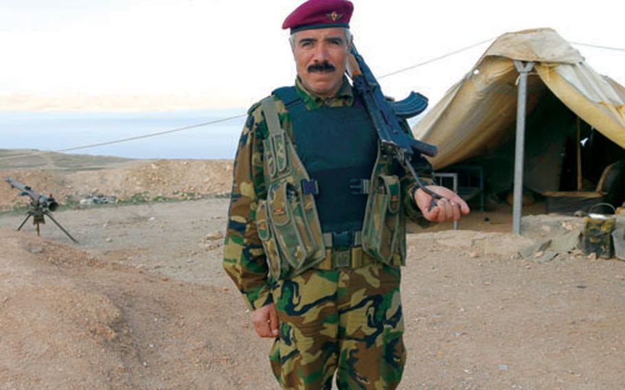 A Kurdish peshmerga soldier stands guard high above Lake Saddam outside of Mosul in this undated file photo.