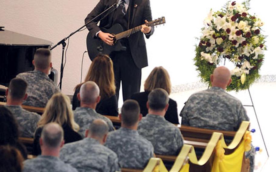 Spc. Michael Woywood performs "Hard to Get" at the memorial service for Sgt. Alexander Westbrooks, Spc. Michael Clark and Spc. Laron Gadson, in Baumholder, Germany, on Wednesday.