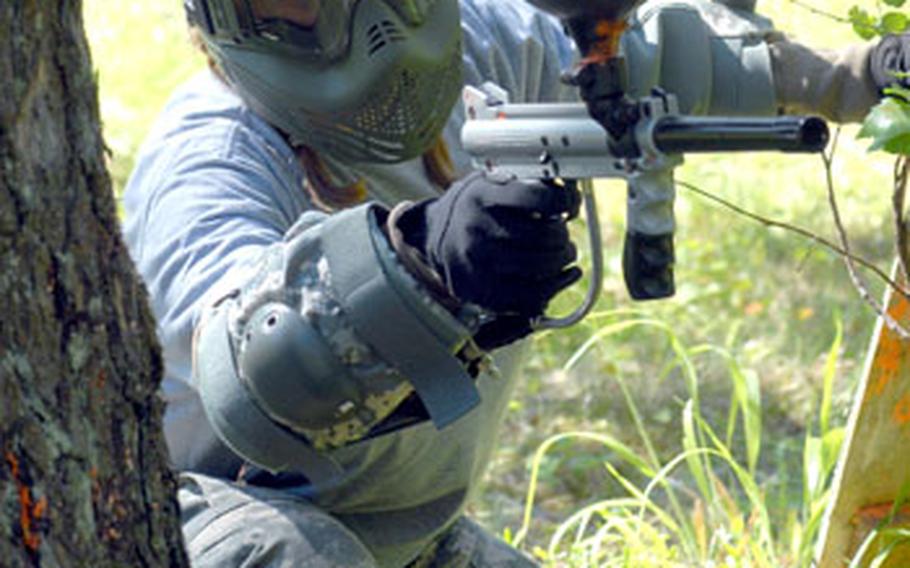 172nd Infantry Brigade spouse Sara Bell takes aim during a paint ball battle that was part of the brigade "Spouses&#39; Shoot" at Grafenwoehr Training Area on Wednesday.