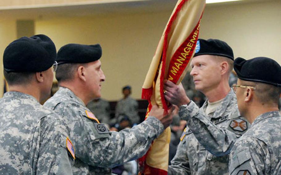 Col. Joseph P. Moore, second from right, is handed the colors of the U.S. Army Garrison-Humphreys during a ceremony at which he assumed command of the garrison. Moore replaces Col. John E. Dumoulin Jr., left, who moves to a new assignment after heading the garrison for two years. Handing Moore the colors is Brig. Gen. John Uberti, commander of the Army’s Installation Management Command-Korea. At right is the garrison’s Command Sgt. Maj. Jason K. Kim.