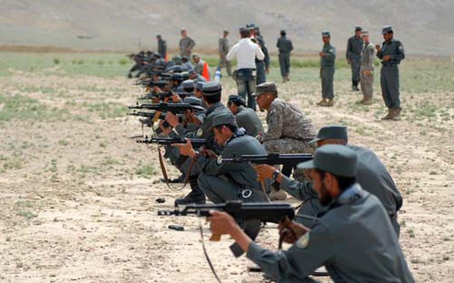 U.S. troops with the Illinois National Guard’s 33rd Brigade Combat Team train new Kabul police recruits to fire AK-47 assault rifles on the grounds of the Kabul Military Training Center on Tuesday. The training is part of an accelerated program to recruit and prepare nearly 5,000 police officers to maintain security during national elections in late August.
