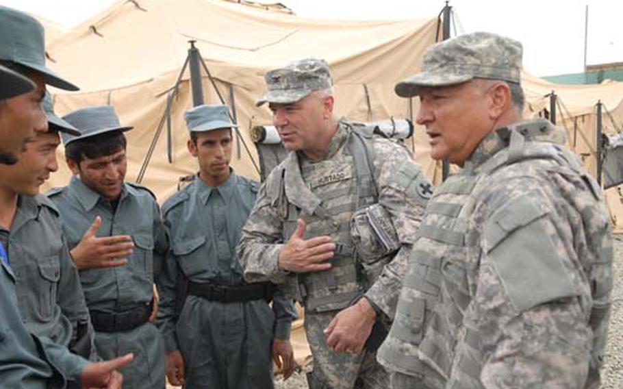 Col. Percy Hurtado of the Oklahoma National Guard, center, commander of the Afghan Regional Security Integrated Command Kabul, and interpreter Abdul Wahidi of Nashville, Tenn., talk with new Afghan police recruits at Fire Station 3 in Kabul, Afghanistan.