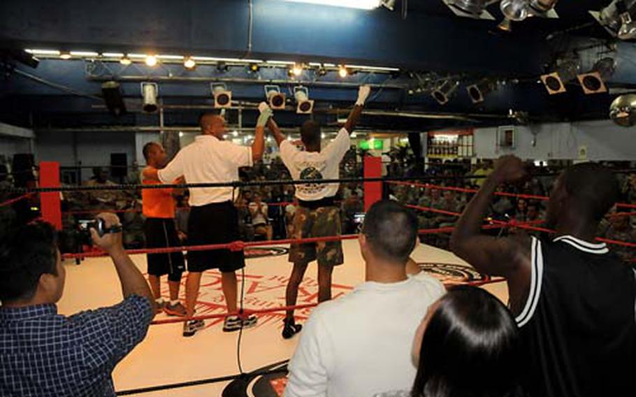 More than 200 soldiers crowded into Tenkaichi Stadium in Chatan Thursday to watch a boxing smoker in which soldiers from various units fought as part of the first Army on Okinawa Week.