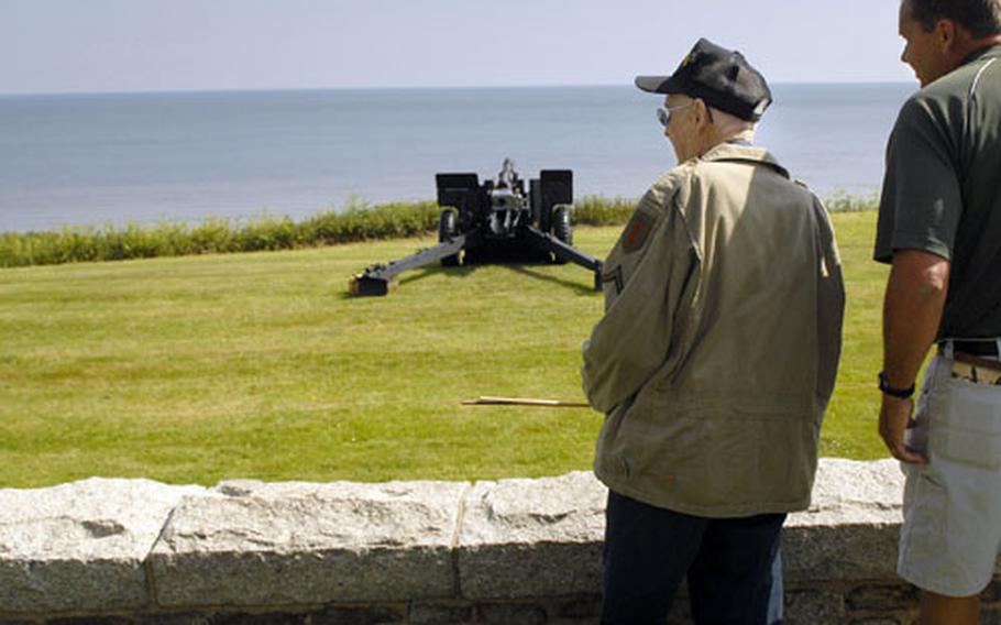 Willie Southerland, 93, left, and Rod Weiss reflect as they over look the beaches at the Normandy American Cemetery.