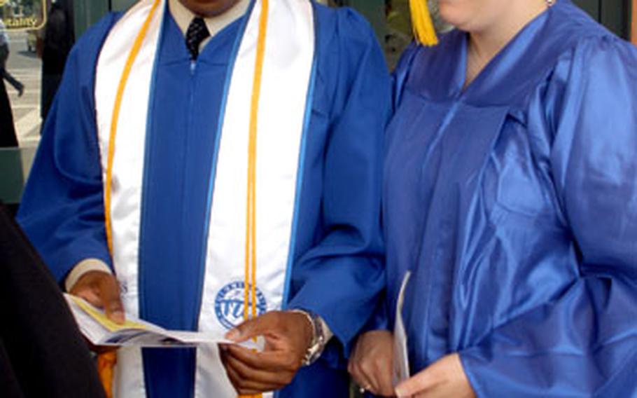 Chief Petty Officer Arthur King, left, and Petty Officer 1st Class Kristi Moon, earned degrees Friday through Touro University International in California. Both had been working toward degrees since 2005.