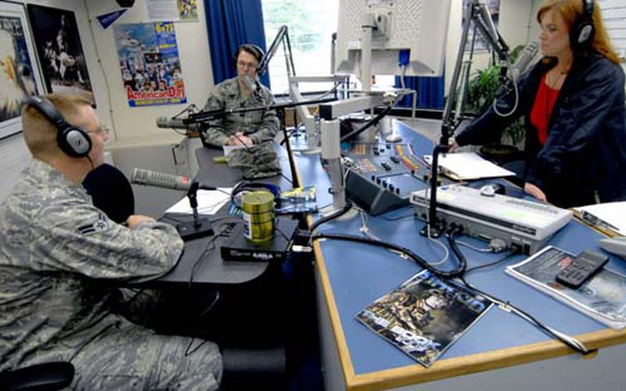 Airman 1st Class Donnie Lang, left, Tech. Sgt. Erick Tyndall, center, and American Forces Network radio deejay Jo Baker give computer advice to the Misawa Air Base, Japan, community during the Geek Squad program Friday morning.