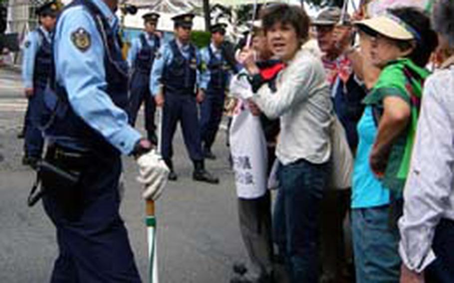 Police guarded protesters from going near the depot after the protesters spread onto the road that runs in front of the depot.