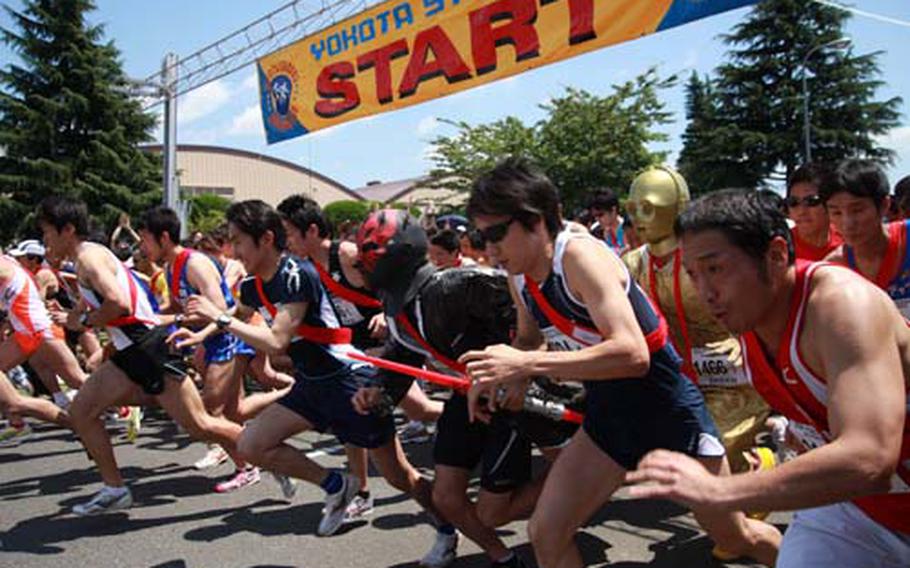 Runners bolt from the start as they began the 5-kilometer stretch of their four-person relay at Yokota Air Base’s Ekiden relay race on Sunday.