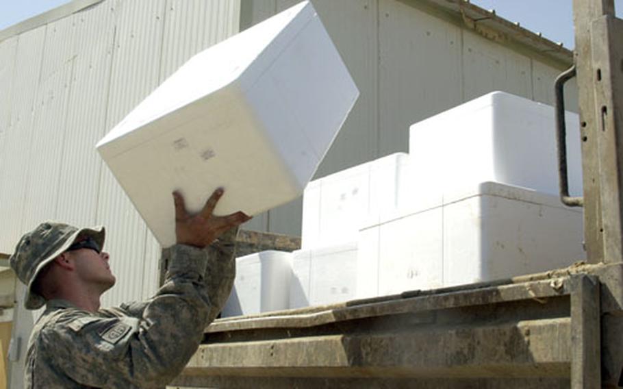 Spc. Philip Russell, 24, of Carthage, N.C., loads boxes of spoiled vegetables onto a garbage truck. As part of the food crew, Ruseell never leaves base. He also almost never gets to spend a day inside. “Occasionally I’ll squeeze in a phone call home,” Russell says about his time off. “It was pretty rough for a while. I had some issues at home and I couldn’t do anything about it. I knew I was slowing down but I didn’t know why.”