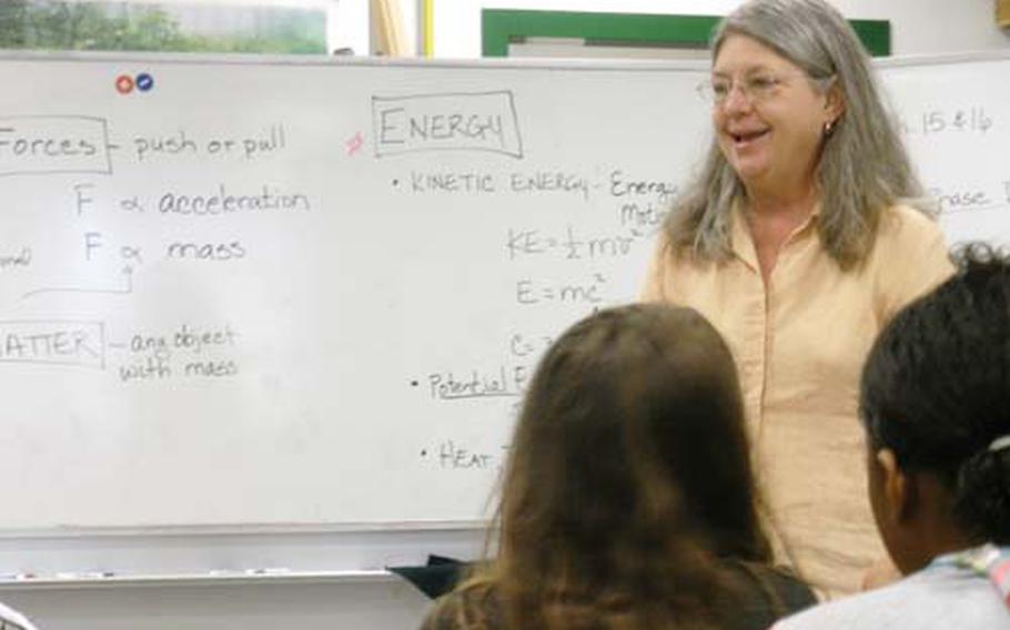 Candace Scott laughs during eighth-grade science class at Naples High School. This summer, she will become the first DODDs teacher to work at the European Organization of Nuclear Research in Switzerland, site of the Large Hadron Collider. She hopes her selection will open opportunities for students to take trips to the lab.