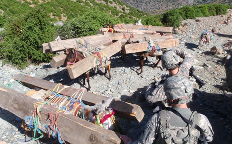 American soldiers with the 1st Battalion, 32nd Infantry Regiment, intercept illegal timber as it is smuggled through the Narang Valley in Konar province, Afghanistan. Military officials say timber smuggling is an even more lucrative way for militant groups in the area to raise funds than the gem or drug trades.