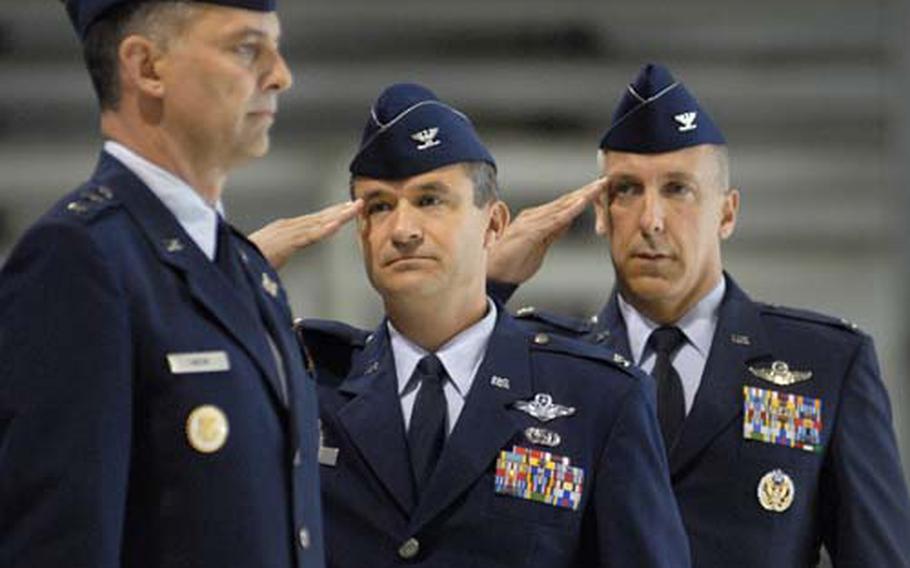Col. Don Bacon, center, and Col. Thomas Gould, right, render a salute to Maj. Gen. Mark Zamzow, 3rd Air Force vice commander, during the 435th Air Base Wing change of command ceremony Thursday in a hanger at Ramstein Air Base, Germany. Gould assumed command of the largest support wing in the Air Force.