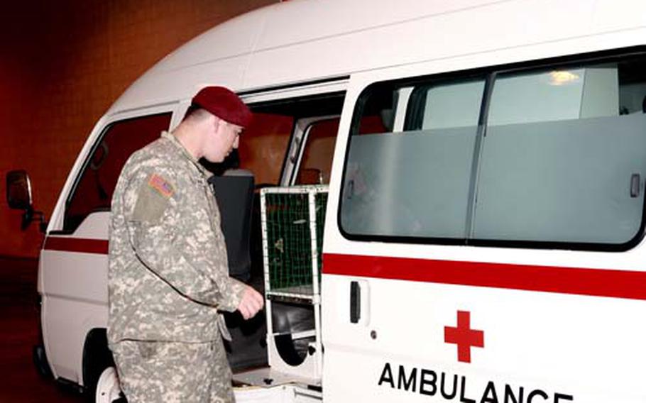 U.S. Army Spc. Lucas Callaghan of the 87th Quartermaster Detachment, Okinawa, inpsects the contents of an ambulance prior to its shipment to Sri Lanka. More than $1.6 million in hospital supplies and vehicles are being shipped to the war-torn island nation.
