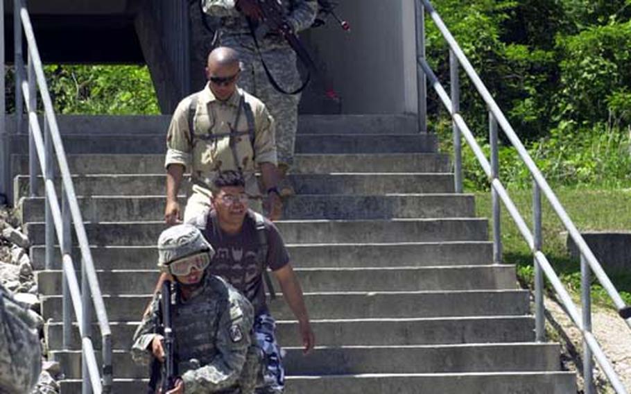 A military policeman responds to sniper fire during a training exercise.