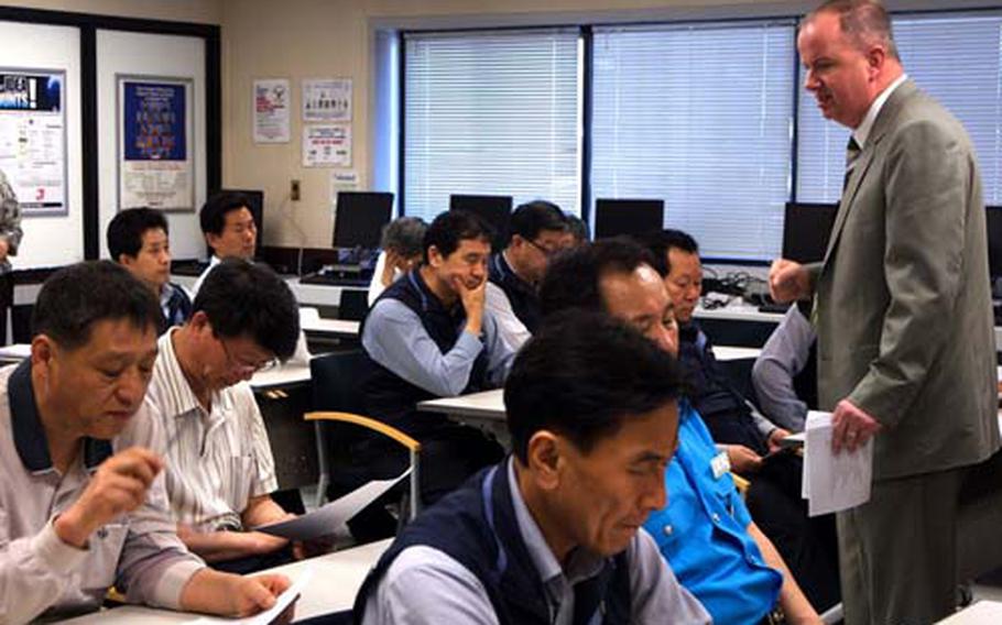 Gregory Dickerson, Emergency Services operations officer at U.S. Army Garrison-Yongsan, teaches a safety class Thursday to South Korean taxi drivers who work at Yongsan Garrison.