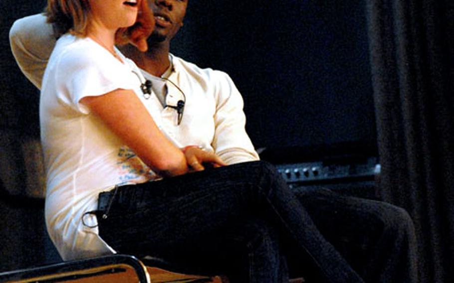 Kyle Terry plays the role of the stereotypical overaggressive young male trying to pick up a woman, played by Courtney Abbott, during a presentation of “Sex Signals” Friday at Misawa Air Base, Japan.