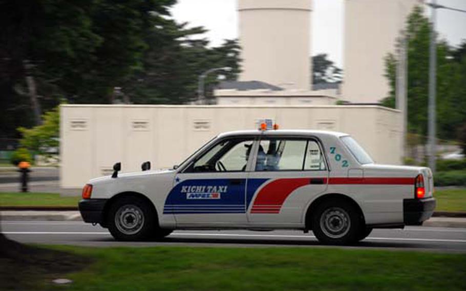 A Kichi Taxi, contracted through the Army and Air Force Exchange Service, drives through Misawa Air Base, Japan, on Tuesday. AAFES officials have worked with Kichi Taxi to provide several new services this month, including an expanded pick-up service which begins Friday.