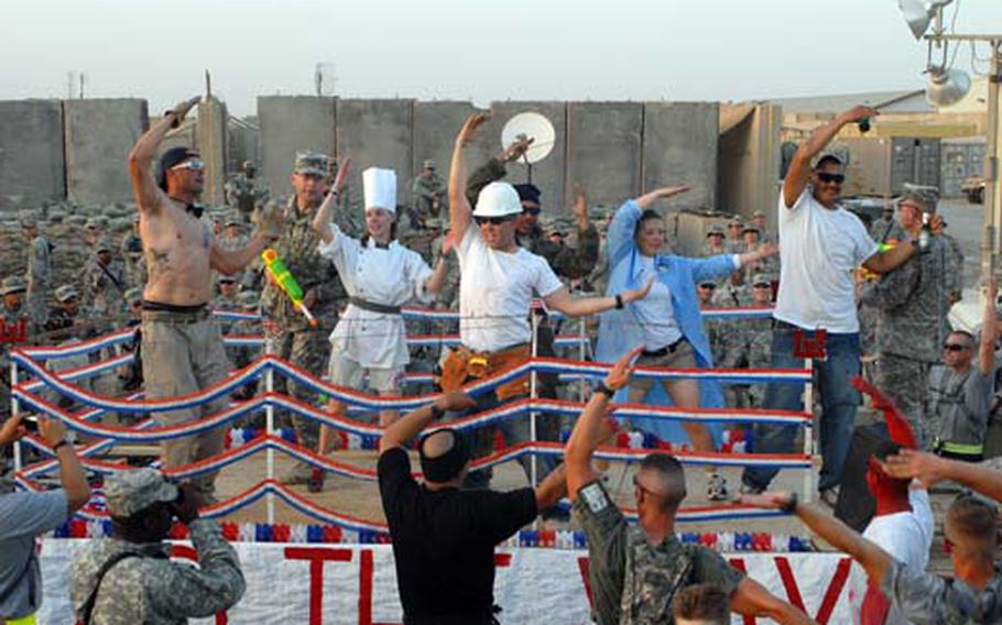 Performers, including 172nd Infantry Brigade commander Col. Jeff Sinclair (second from left) dance on a float during a parade at Forward Operating Base Kalsu on Sunday to mark the Army&#39;s 234th Birthday.