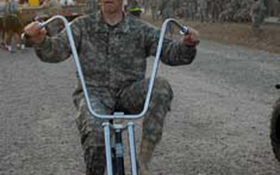 172nd Infantry Brigade commander Col. Jeff Sinclair rides a bike during a parade at Forward Operating Base Kalsu.