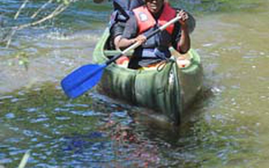 Rayshan Clark of Vilseck and Dimitri Clarke of Ansbach, paddle up the river during an outdoor education class.