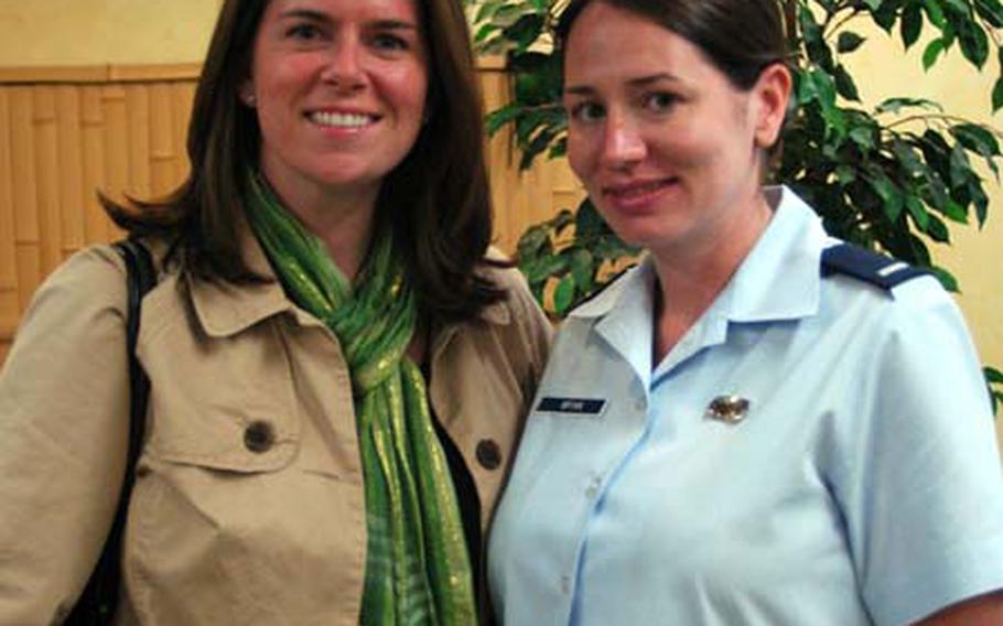 Left: Laura Lange (left) and 1st Lt. Tania Bryan, deputy public affairs officer for the 374th Airlift Wing, pose for a picture. Both of their spouses are members of the 36th Airlift Squadron at Yokota Air Base and are currently deployed to Southwest Asia.