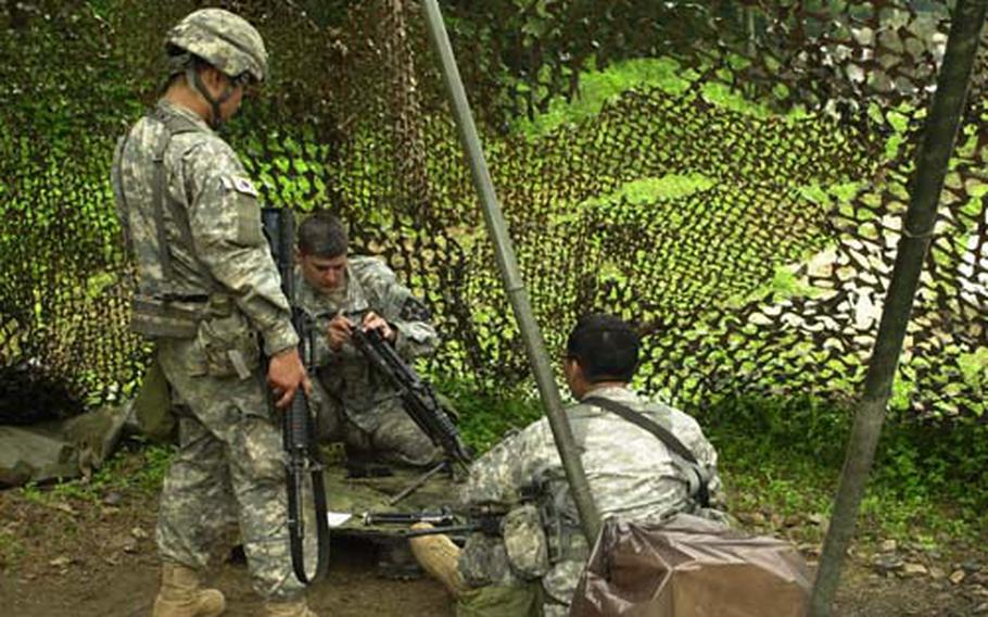 Soldiers practice taking apart a weapon and putting it back together during Expert Infantry Badge testing this week at Camp Casey.