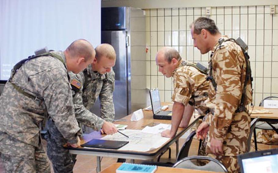 From left, U.S. Army Staff Sgt. Kenneth Beutler and Chief Warrant Officer Two Tom Mirto work with Romanian army Maj. Vale Roman and Romanian army Capt. Dan Huduma to train in a simulated Tactical Operations Center before they deploy to Afghanistan together in the late summer.