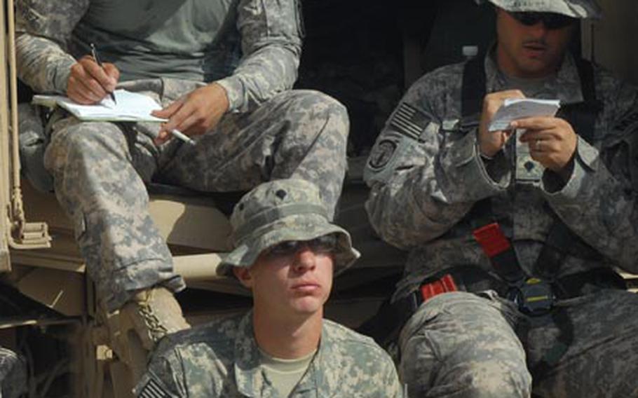 From left: Members of 2nd Platoon, 563rd Military Police Company - Spc. Michael Feraco, Spc. Trenton Kershner, and Spc. Jose Ramirez - prepare for a patrol at Forward Operating Base Kalsu on Monday.