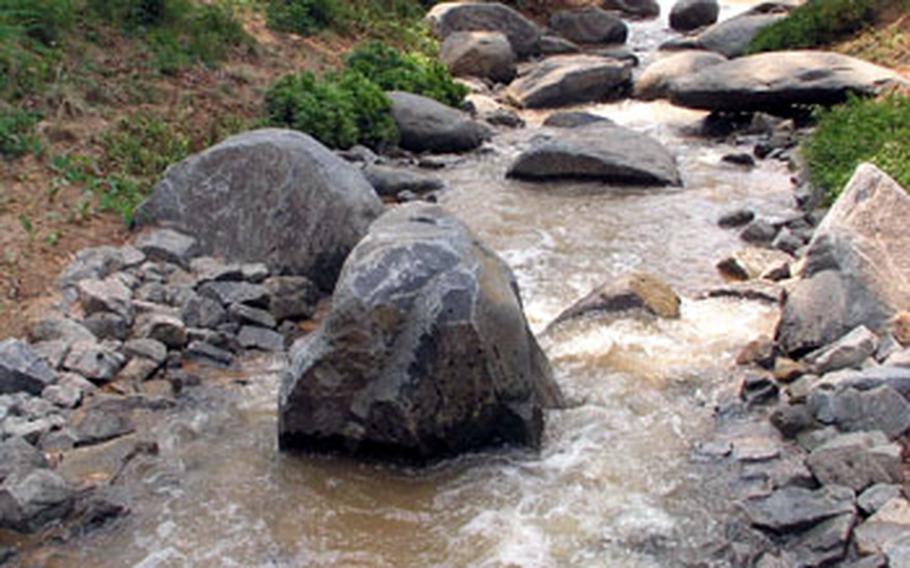 At Camp Humphreys, a new storm water retention basin also serves as a scenic spot where soldiers and others can relax amid trees, flowers and water flowing over rocks.