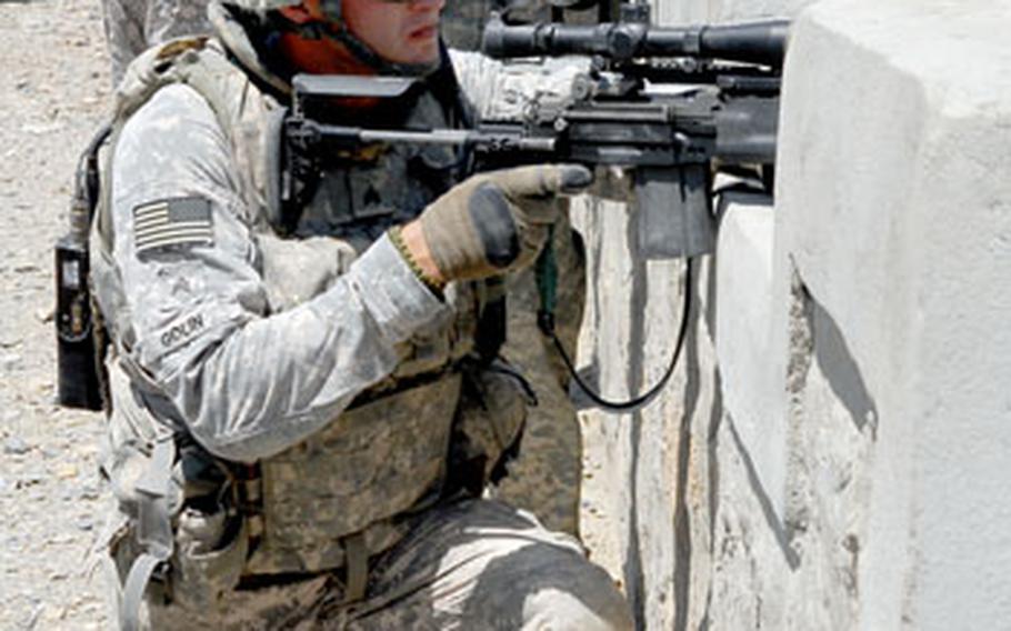 NATO coalition soldiers from 2nd Platoon, Dog Company of the 4th Brigade, 25th Infantry Division out of Alaska, take up firing stances after a U.S. convoy was ambushed Saturday in Samawat.