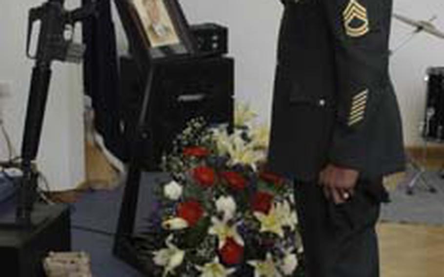 Sgt. 1st Class Michael Cogborn, of the 2nd Military Intelligence Battalion, salutes the display following a memorial service for 2nd Lt. David J. Hartig in the chapel on Wiesbaden Army Airfield, Germany, on Tuesday. Hartig was found dead in his home earlier this month. The cause of his death is under investigation.