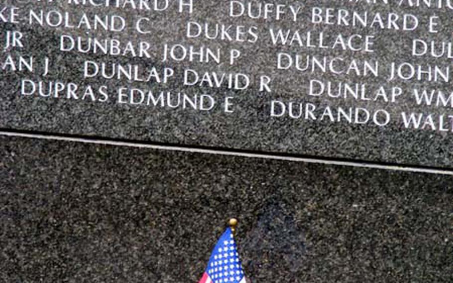 A small American flag flutters in front of a wall containing the names of some of the U.S. troops killed during the Battle of Okinawa. Tuesday marked the 64th anniversary of the end of the 83-day battle at the end of World War II.