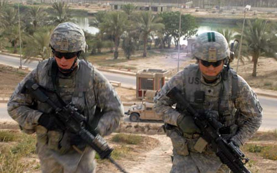 In this file photo, from left, Sgt. Elton East, 22, of Asheboro, N.C., and Spc. William Watai, 24, of Barstow, Calif., both of the 172nd Infantry Brigade, patrol Babil province in Iraq in June of 2009.
