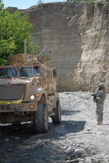 A coalition soldier with 3rd Platoon, Company D of the 4th Brigade, 25th Infantry Regiment out of Alaska stands in a canyon in the Nader Shah Kot district in eastern Afghanistan. The platoon pushed northward up the wadi past Shembowat into what is perceived as hostile territory in order to make contact and speak to villagers about polling locations ahead of the August presidential elections.