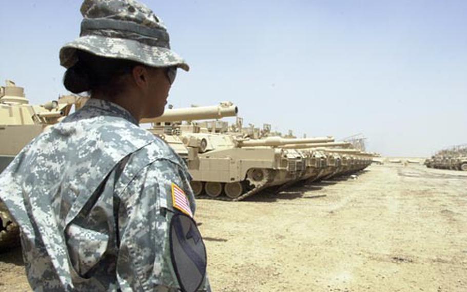 Maj. Mekelle Epperson looks over the vehicles.
