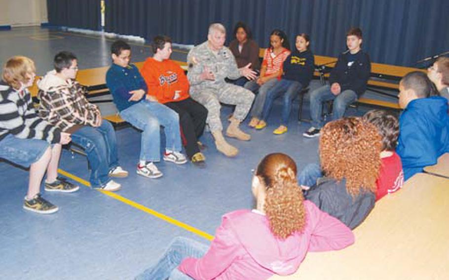 Gen. Carter F. Ham, U.S. Army Europe commanding general, talks with Heidelberg Middle School students about their concerns during an informal meeting in the school’s multipurpose room in February. The Europe Regional Medical Command will place mental health counselors in two DODDS’ communities next year to help students cope with their parents’ deployments.