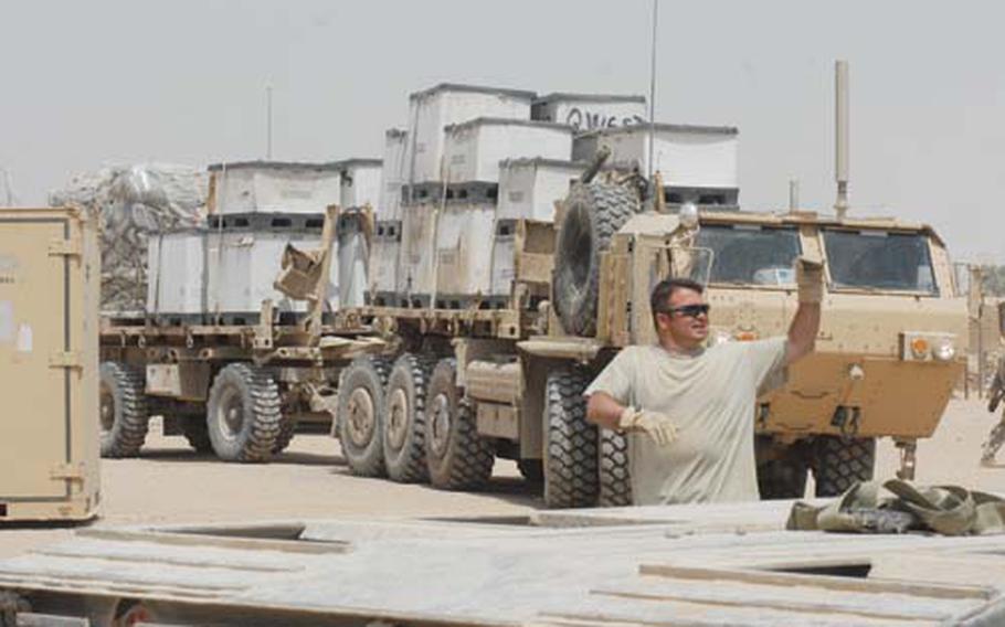 U.S. Special Forces soldiers move gear out of Camp Tarlovsky in Najaf, Iraq, on Saturday. They were moving to Forward Operating Base Endeavor, just outside Najaf. The camp was closing at the request of Najaf’s new governor and as Tuesday’s deadline loomed for U.S. troops to pull back from cities.