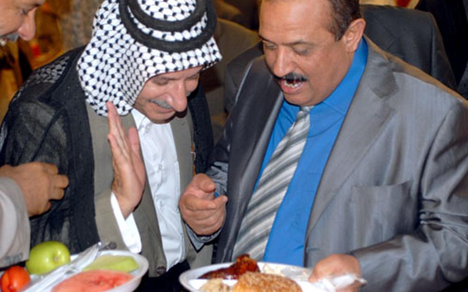 Iraqis seem amused by American food at a July Fourth party at Forward Operating Base Echo on Friday.