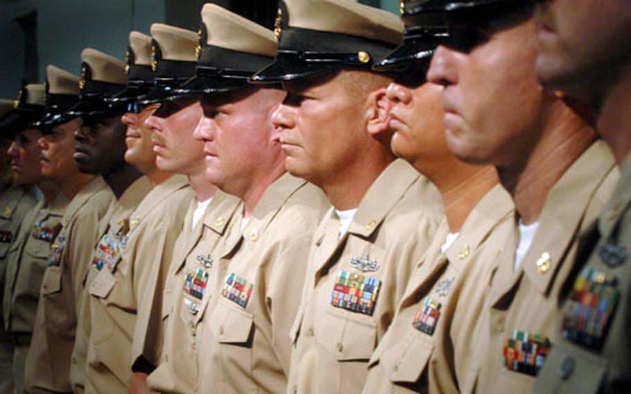 Newly-pinned chief petty officers stand at attention during Naval Station Guantanamo Bay's chief pinning ceremony in September, 2008.