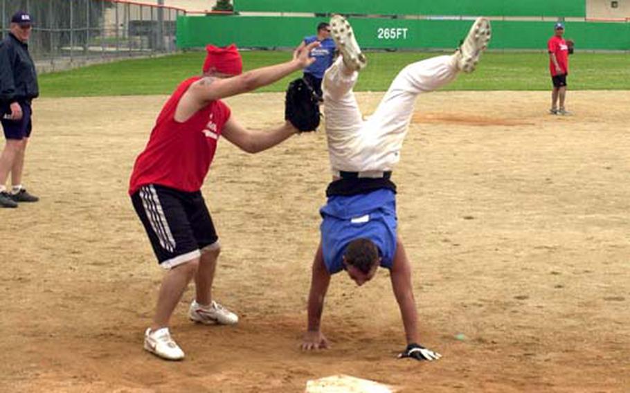 A Warriors player crosses home plate doing a handstand during last week’s successful attempt by members of the 2nd Infantry Division to break the world record for longest continuous softball game. The game lasted 100 hours and ended Saturday.