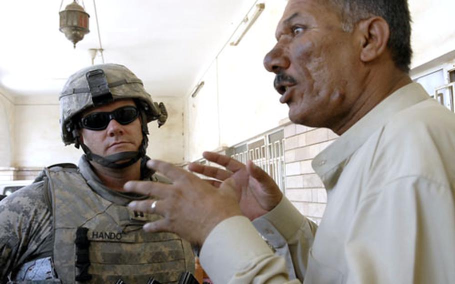 U.S. Army Capt. Tom Hondo listens to Sheik Abdul Mahsin Sa'adoon, a tribal leader in a Diyala province village. Like many Iraqis, Sa'adoon is concerned the recent U.S. pullback from Iraqi cities could lead to an increase in violence.