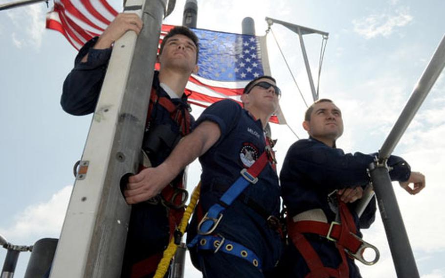Seaman Zachary Potter, Petty Offiicer 1st Class Justin Melody and Petty Officer 3rd Class Jesse Farias observe from the bridge of the USS Seawolf while the boat surfaces in the Pacific Ocean in May.