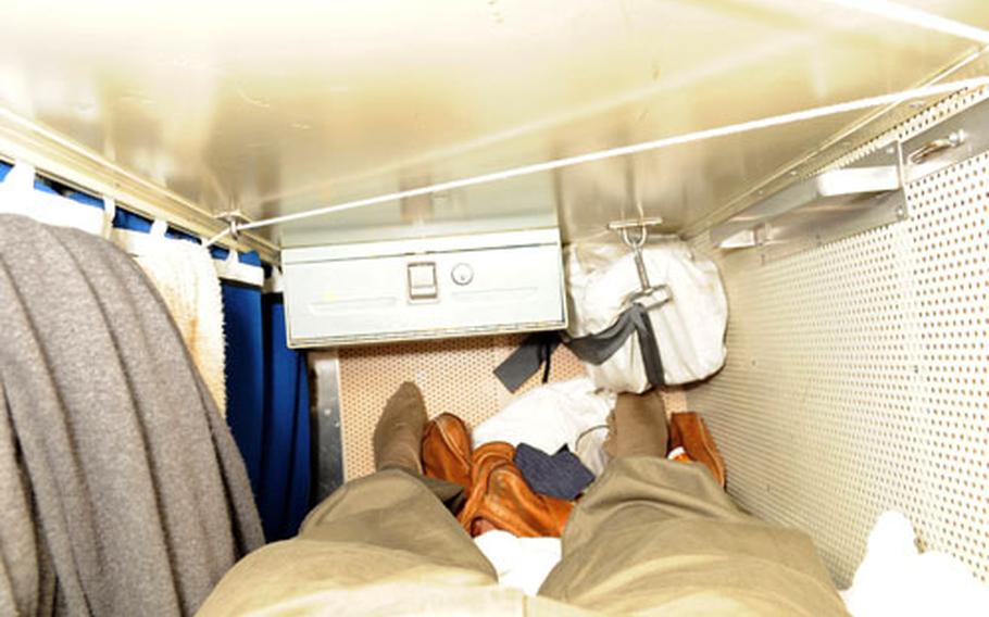 The racks in the 38-man berth are just long enough to accommodate an American male of average height, and no more. With space at a premium, sailors also find ways to hang their clothes, towels and possessions inside their rack.