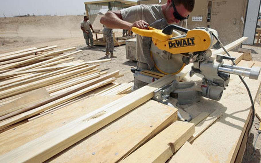 Staff Sgt. Michael Laird, 32, of Plainwell, Mich., a construction specialist with the Air Force’s 1st Expeditionary Redhorse Group, cuts a 2x4 stud to length as he and other airmen work to build a headquarters building for the 82nd Combat Aviation Brigade at a new U.S. base at Tarin Kowt, in Uruzgan province, Afghanistan.